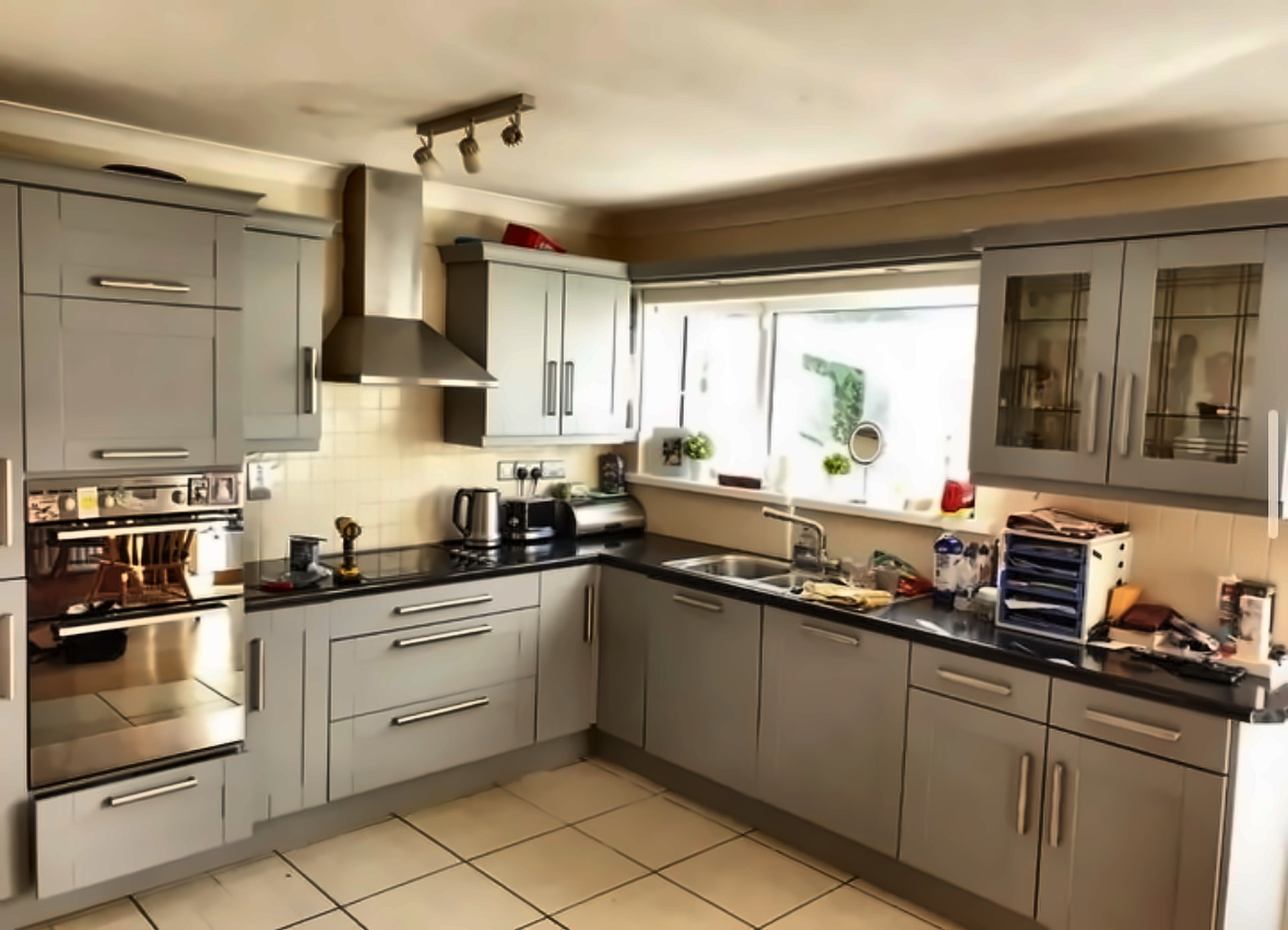 Modern grey resprayed kitchen with black worktops in a Dublin home